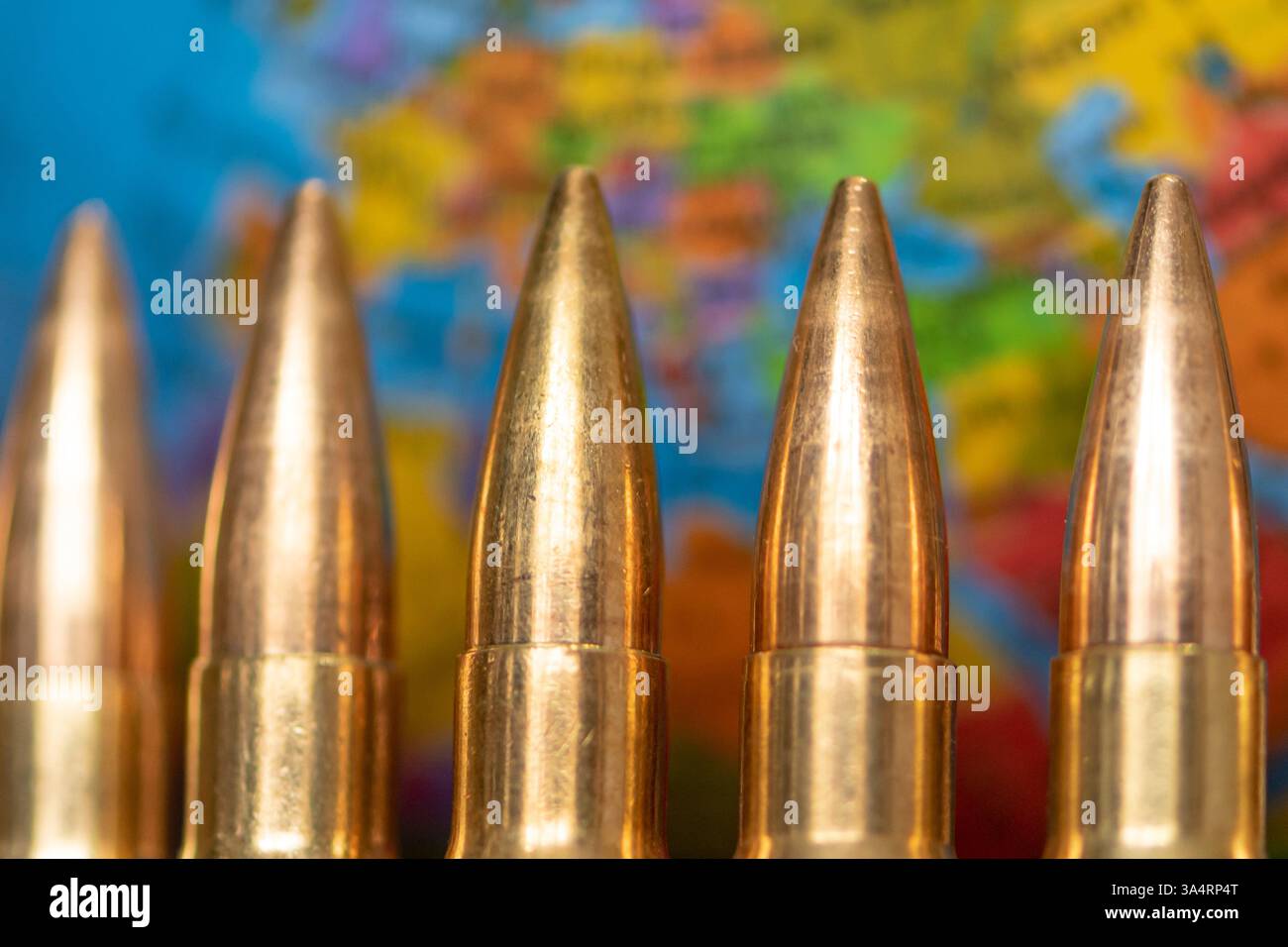 A globe surrounded by bullets as a symbol of the arms race, international rivalry and the threat of armed conflicts. Conceptual photography for themes Stock Photo