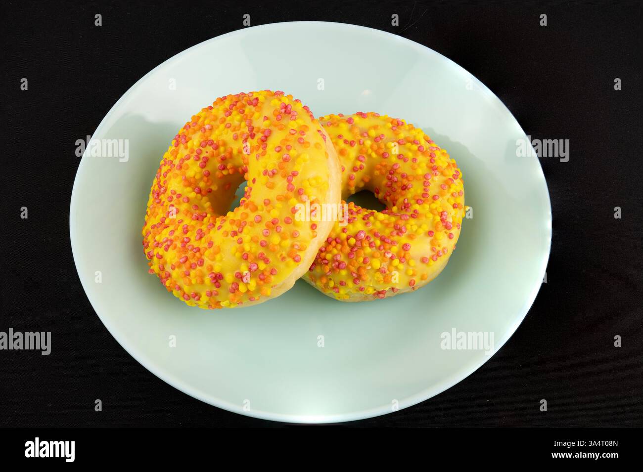 Golden Donuts on a Black Background Stock Photo