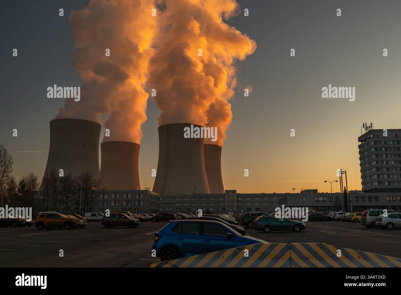 Big chimneys with white smoke in winter sunny day near nuclear power plant in Temelin CZ 02 04 2025 Stock Photo
