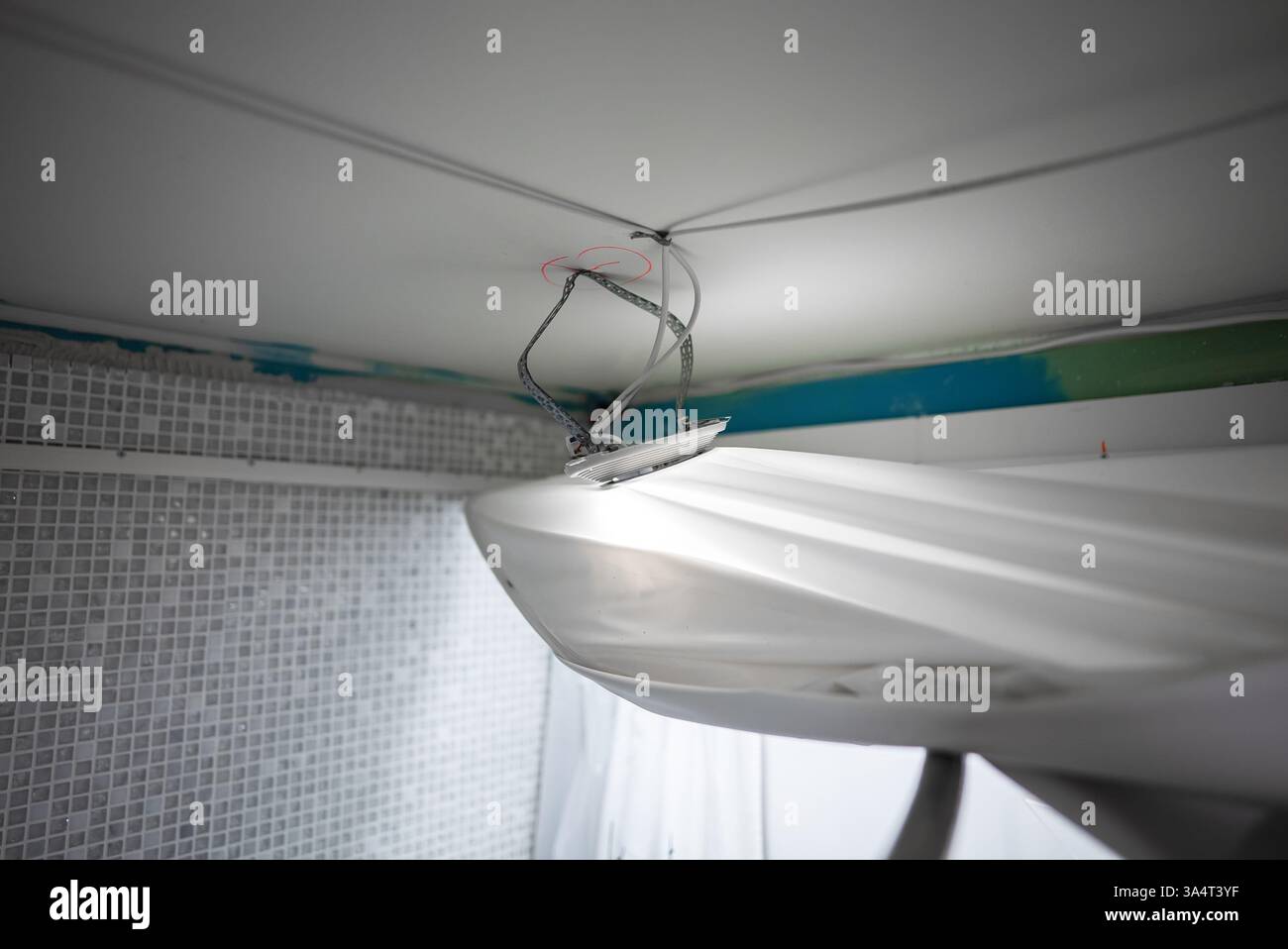 Replacing the stretch ceiling in the bathroom. Stock Photo