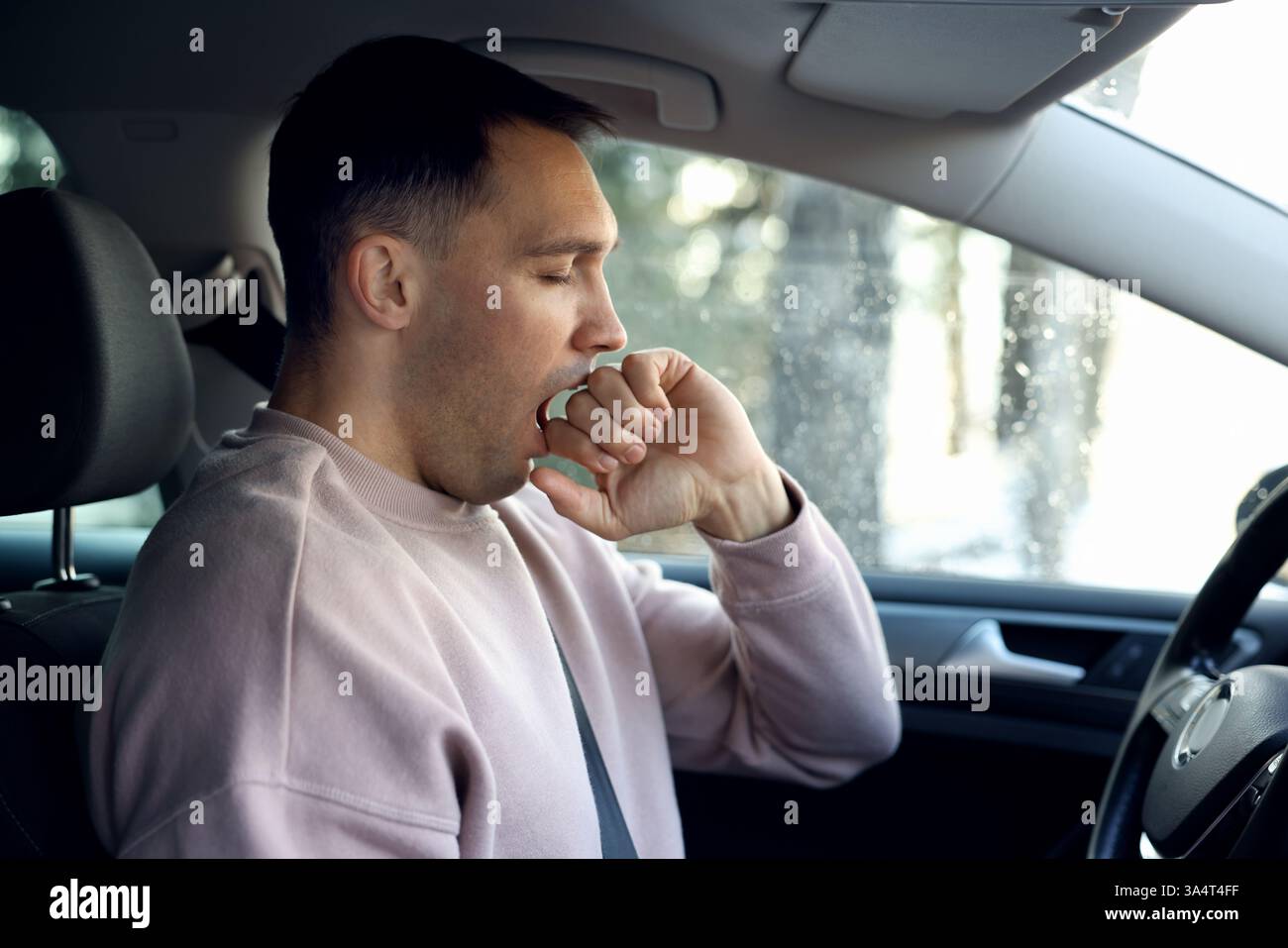 Sleepy driver yawning in his modern car Stock Photo - Alamy