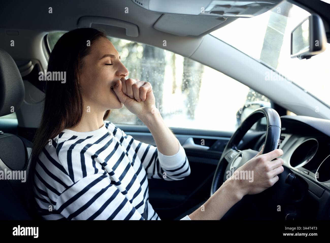 Sleepy driver yawning in her modern car Stock Photo - Alamy