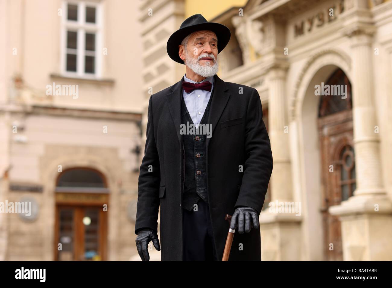 Elegant senior man with walking cane on city street Stock Photo - Alamy