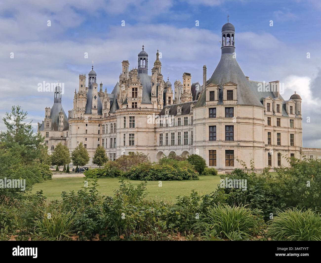 Chateau de Chambord a majestic medieval castle with green gardens. Beautiful palace in the region of Loire, France - Smartphone Captured Stock Image