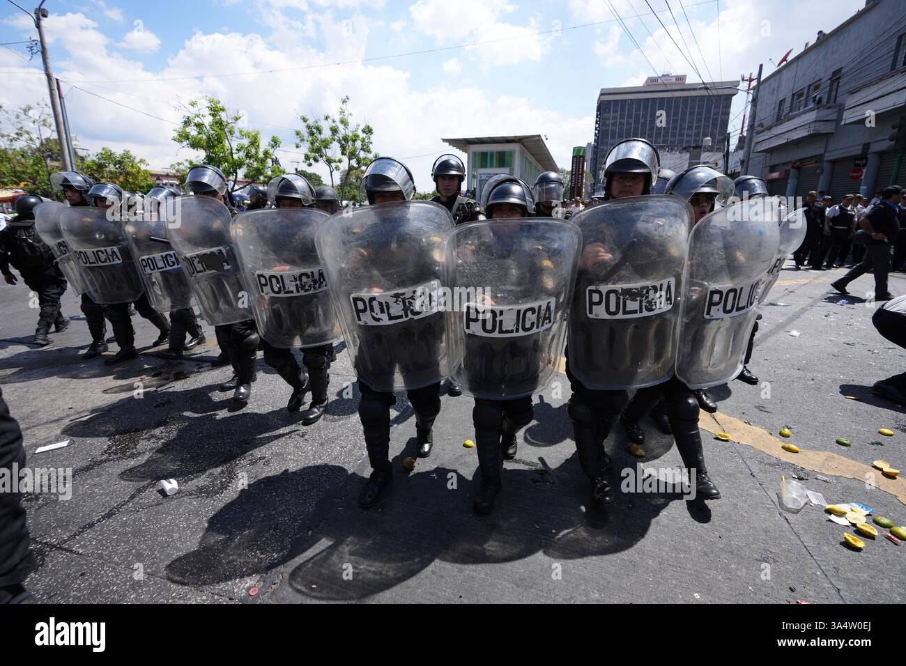 Riot police take position during a protest against a new regulation ...