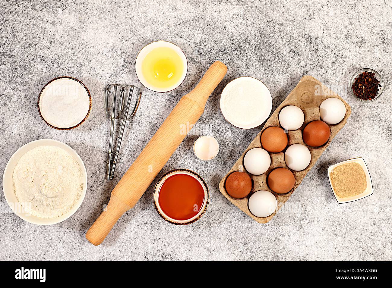 Kitchen background of food preparation.Culinary ingredients for making pie and bread,recipe with eggs,flour,sugar,honey,cinnamon,yeast and butter.Conc Stock Photo