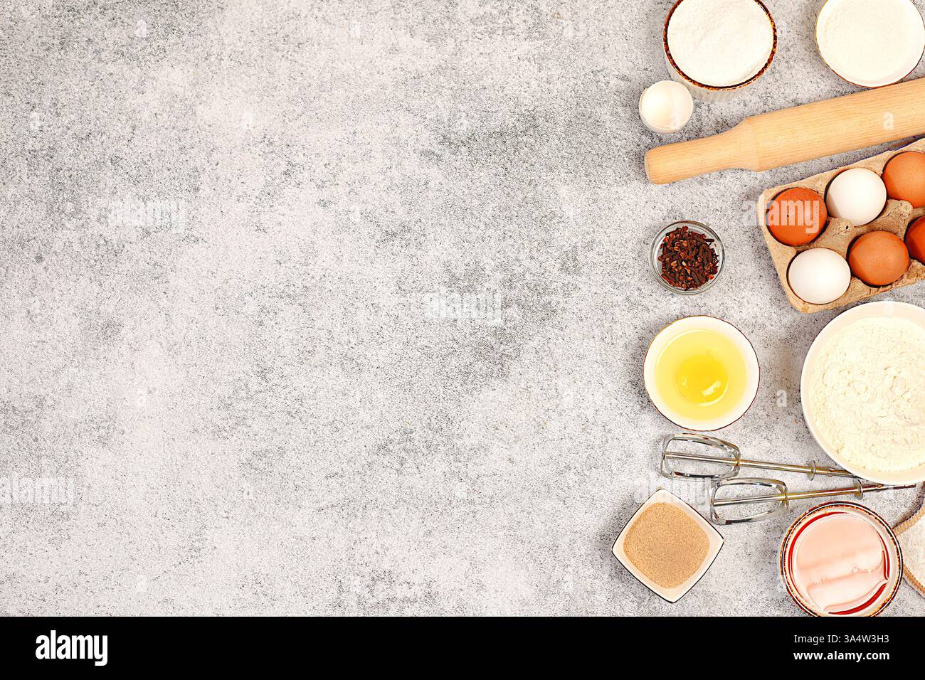 Cooking ingredients for making pie and bread, recipe with eggs, flour, sugar, honey, cinnamon, yeast and butter. Kitchen background of food preparatio Stock Photo