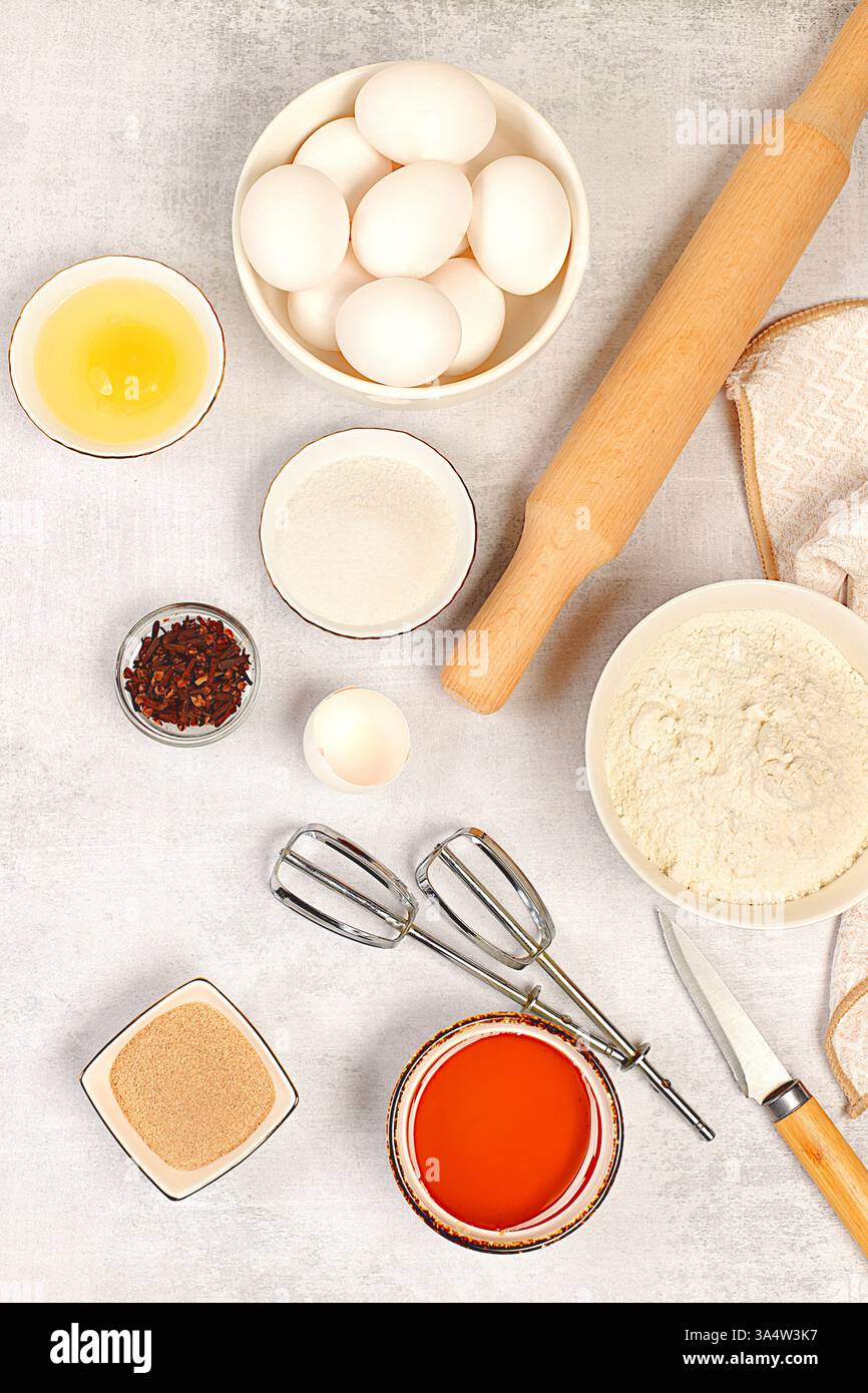 Cooking ingredients for making pie and bread, recipe with eggs, flour, sugar, honey, cinnamon, yeast and butter. Kitchen background of food preparatio Stock Photo