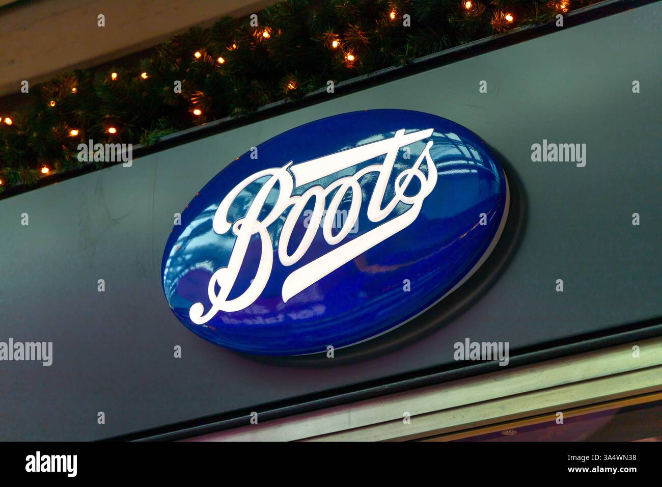 Boots logo above the shop entrance, Boots is a British health and beauty retailer and pharmacy chain in the United Kingdom. Stock Photo