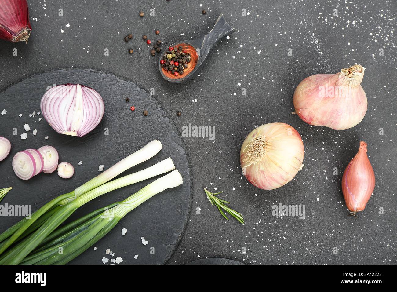 Board with different kinds of onion on grunge black background Stock ...
