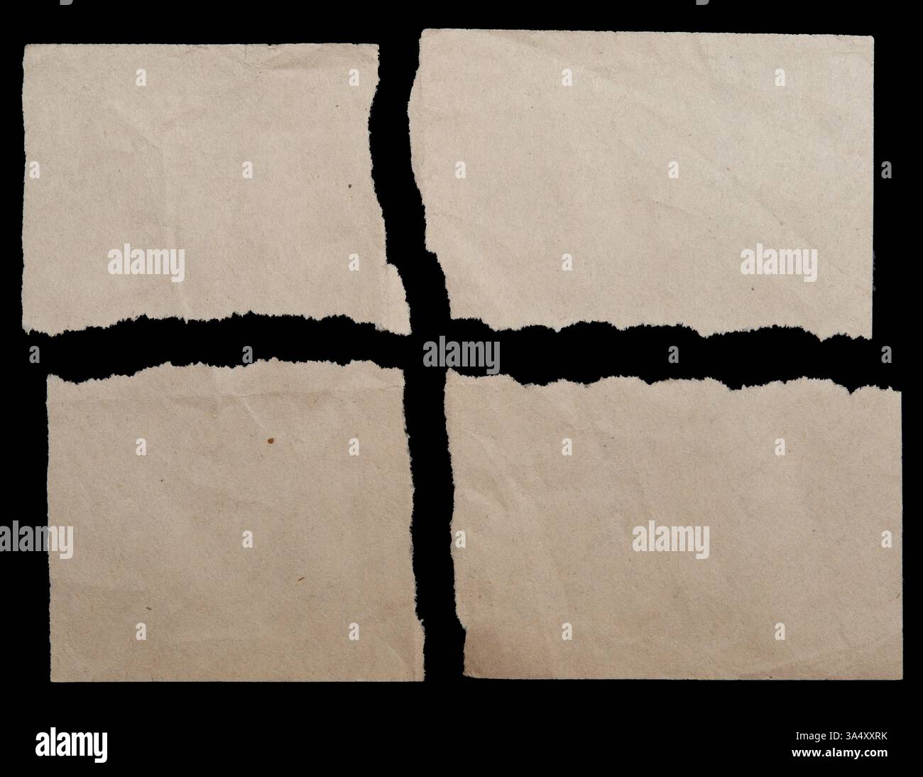 Brown torn paper pieces on black background Stock Photo