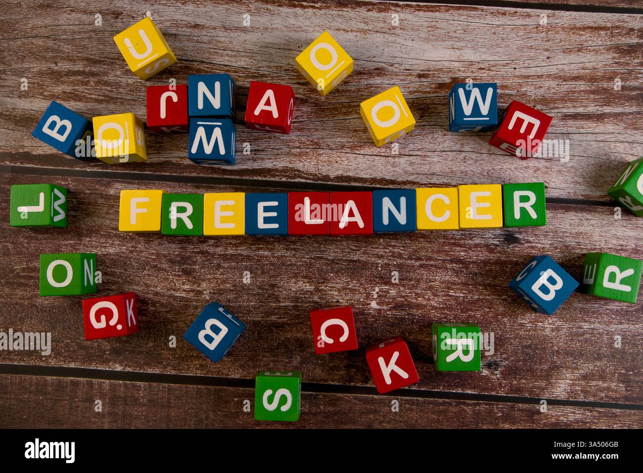 Colorful blocks spell freelancer on rustic wood, showcasing creativity ...