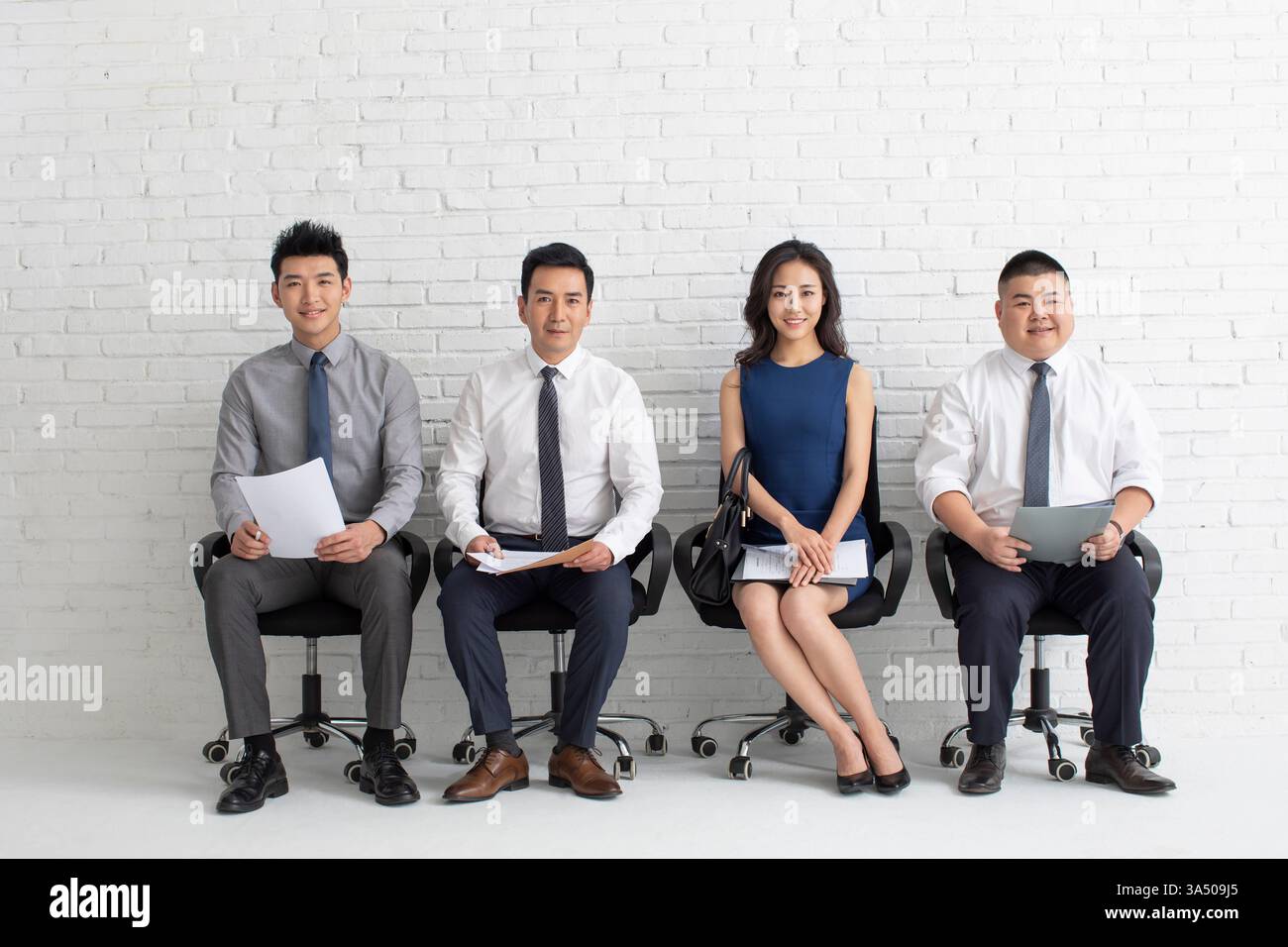 Smiling Chinese female and male job applicants holding folder with ...