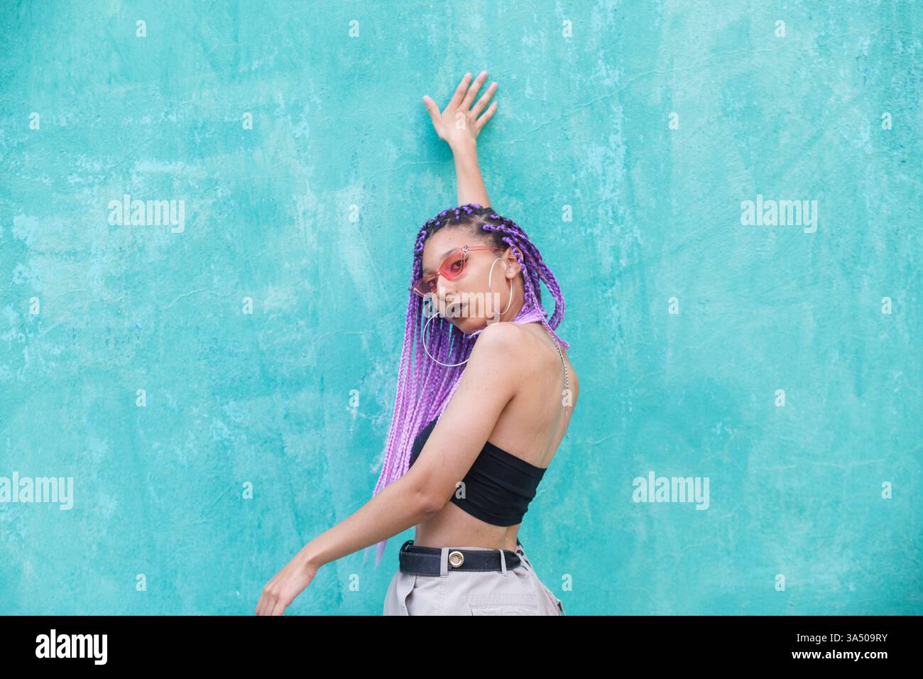 Striking urban portrait of a stylish Black woman with purple braids and ...