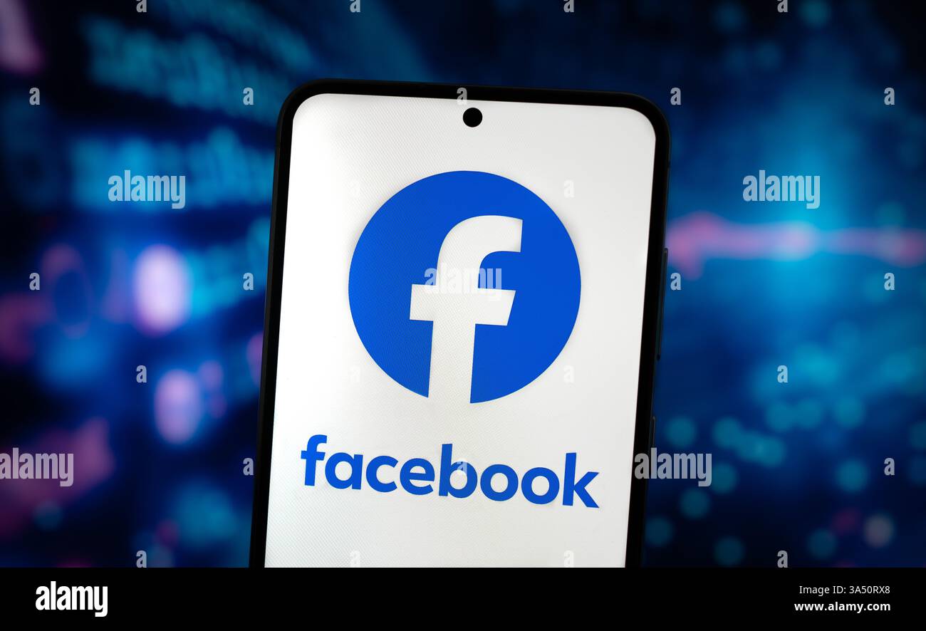 Facebook logo displayed on mobile device Stock Photo