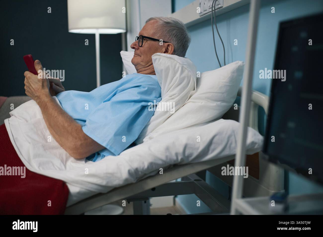 Senior Man Using Smartphone In The Ward Stock Photo