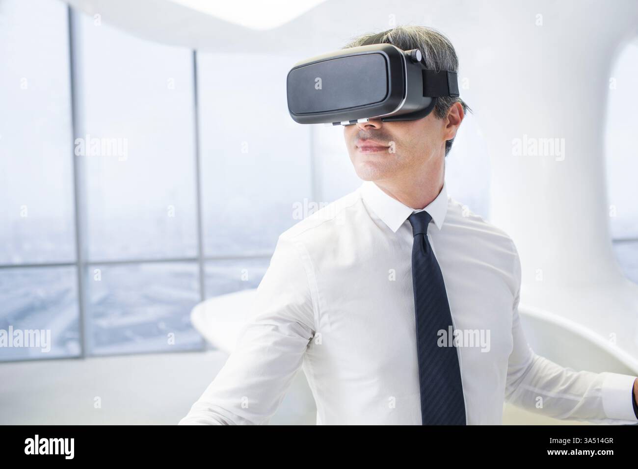 Chinese businessman wearing VR glasses in office Stock Photo - Alamy