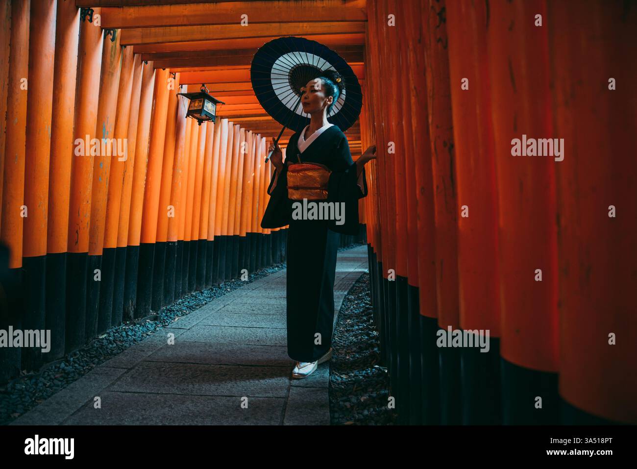 Beautiful Japanese senior woman walking through the Fushimi Inari ...