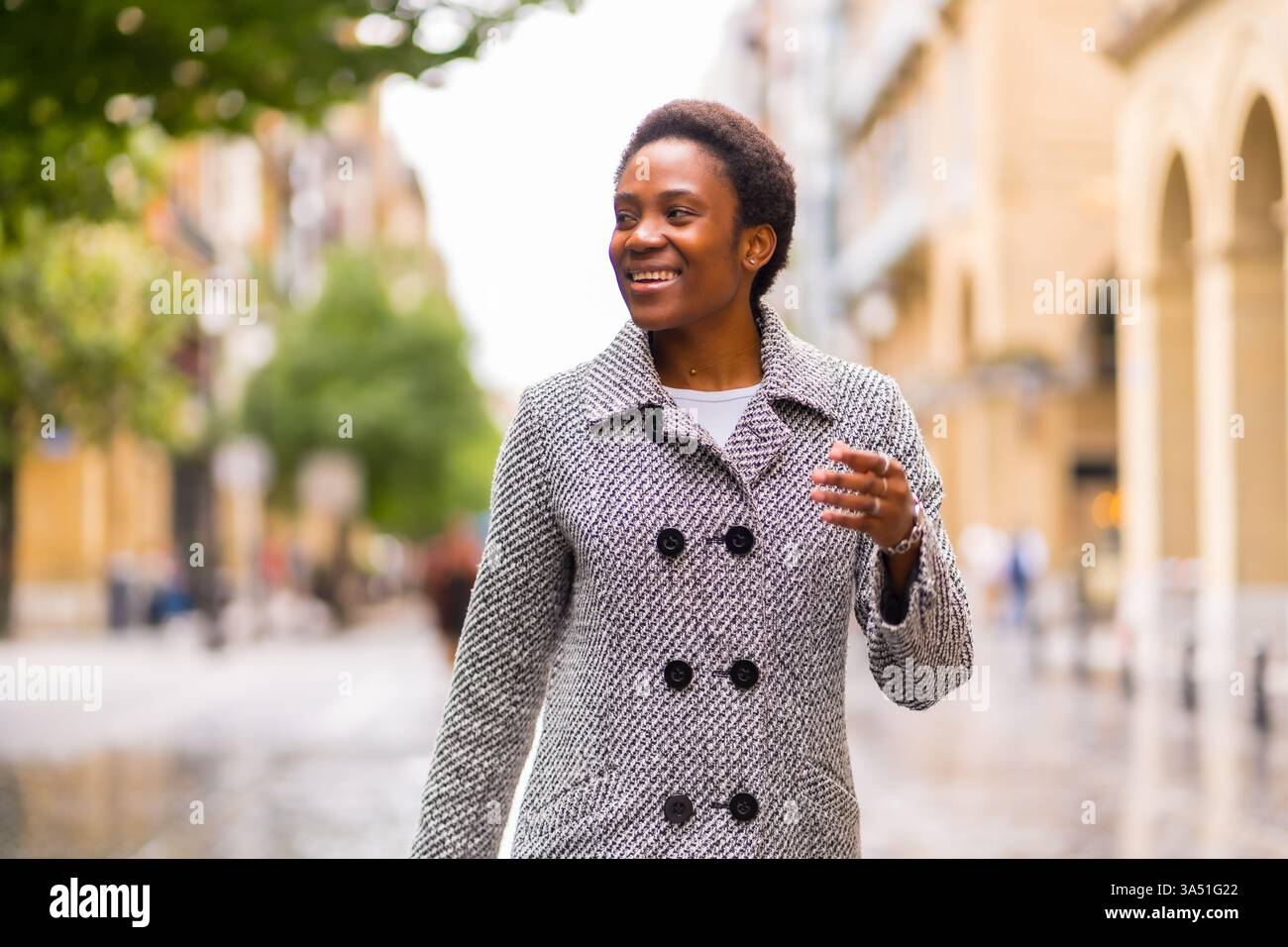 Portrait of a Black businesswoman walking on a city street. A confident ...