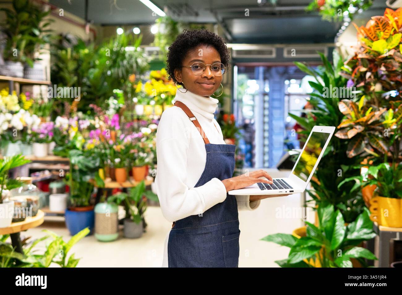 Retail shop owner with laptop