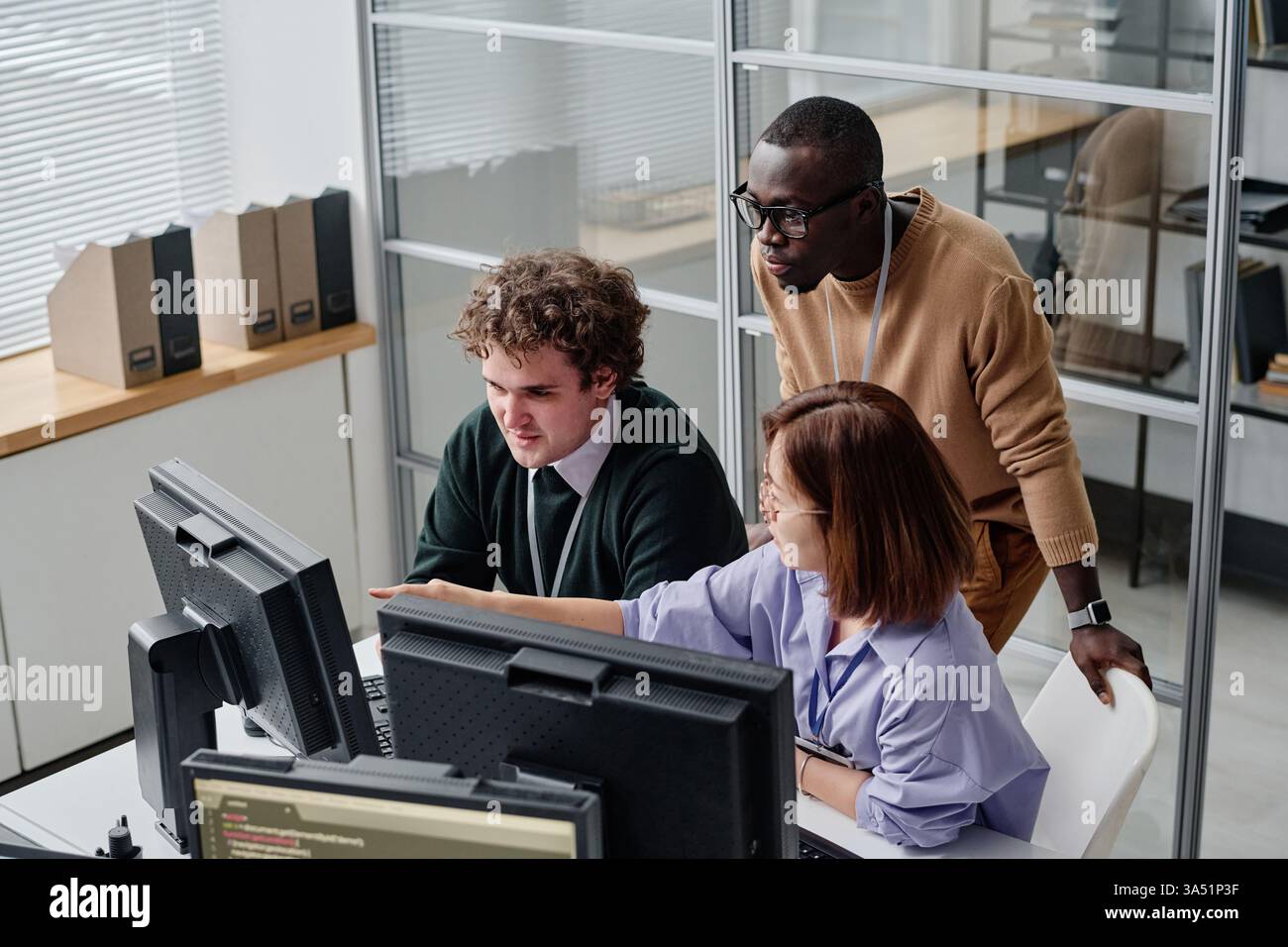 Diverse group of programmers developing security program on computers during their work in office Stock Photo