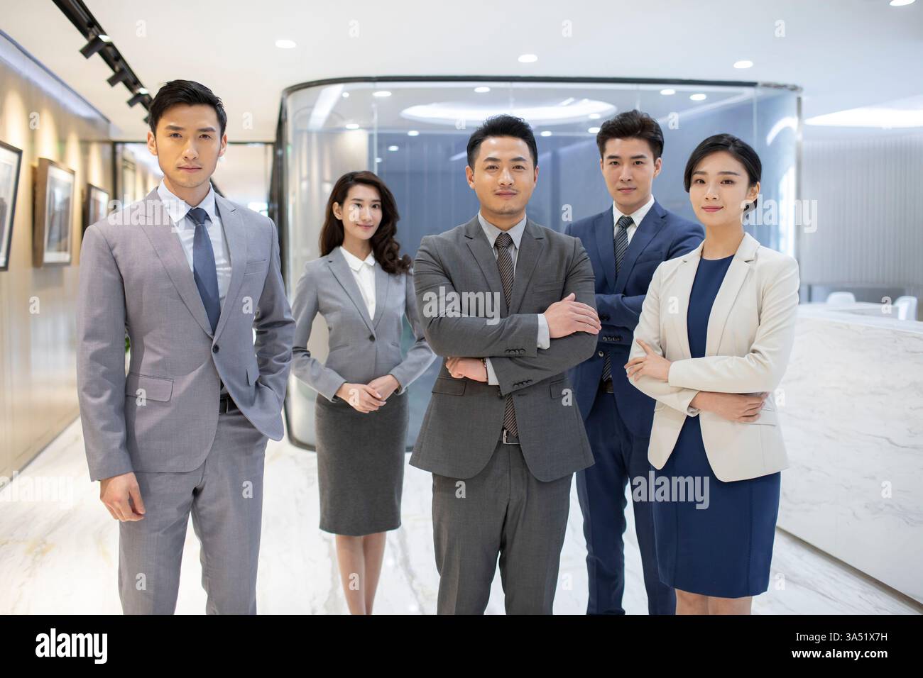 Serious Chinese business people standing together in office Stock Photo ...