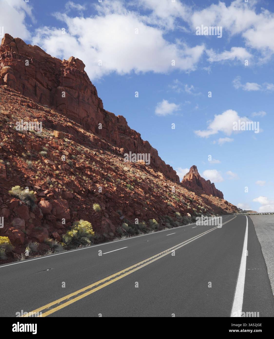 The magnificent marked American road passes between rocks of red ...