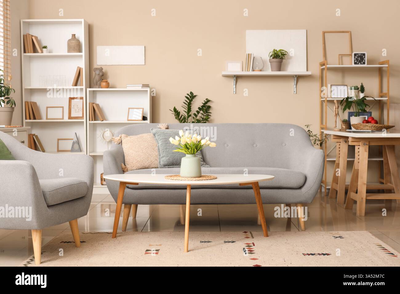 Interior of stylish living room with sofa, coffee table and shelving ...