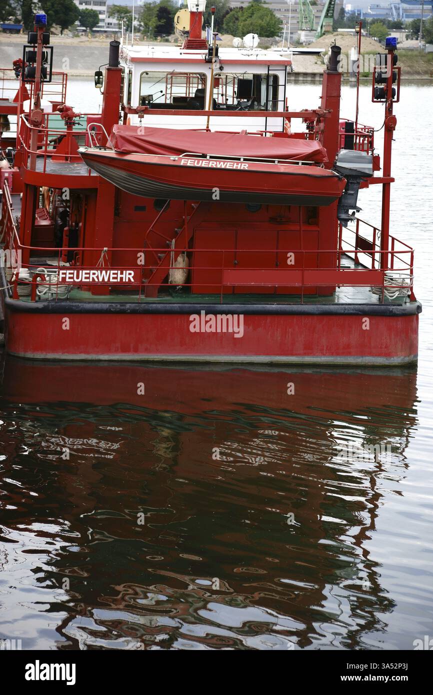 A fire brigade fireboat anchored at a river pier Stock Photo - Alamy