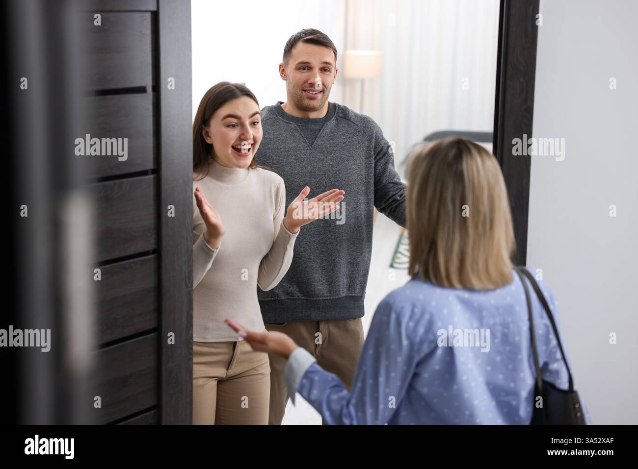 Photo inspiration: Visual Reference: Lovely Couple Welcoming Friend To Their Apartment Stock Photo
