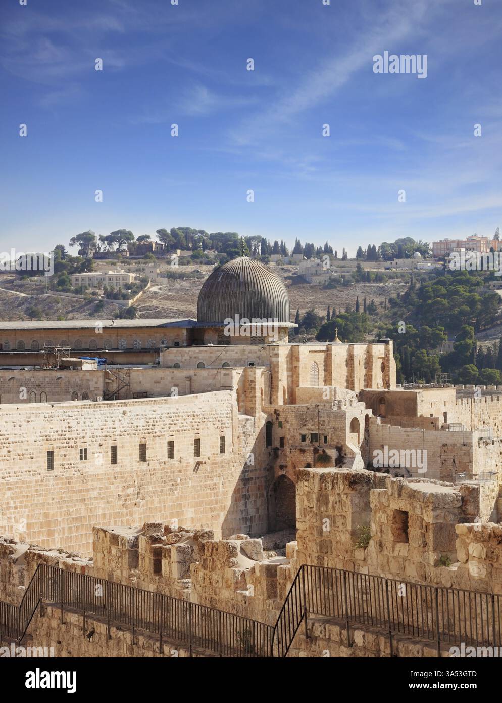 The ancient walls of Jerusalem, lit morning sun. The dome of the Al ...