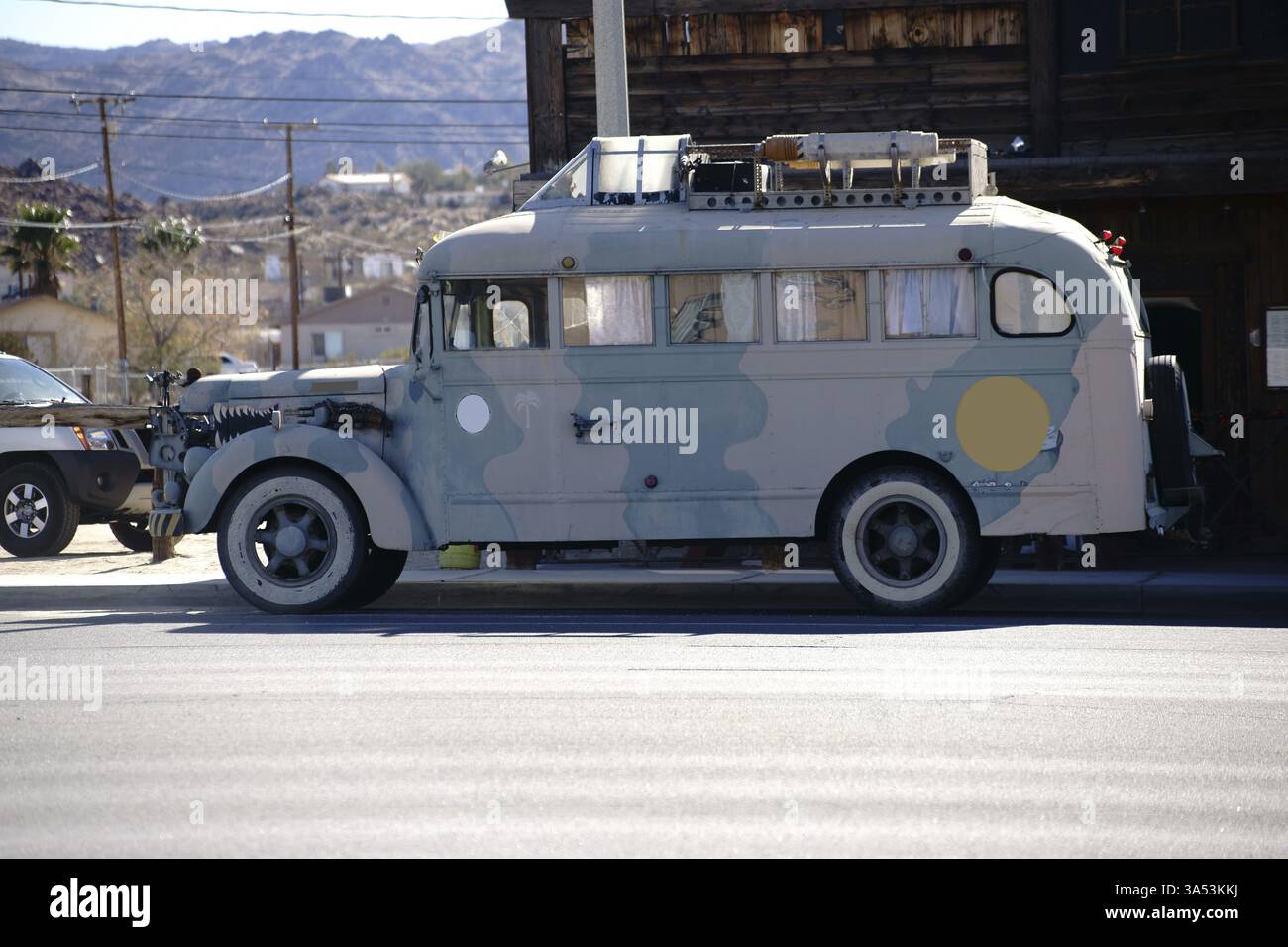 An old hippie camper van parked on a street in front of a restaurant ...