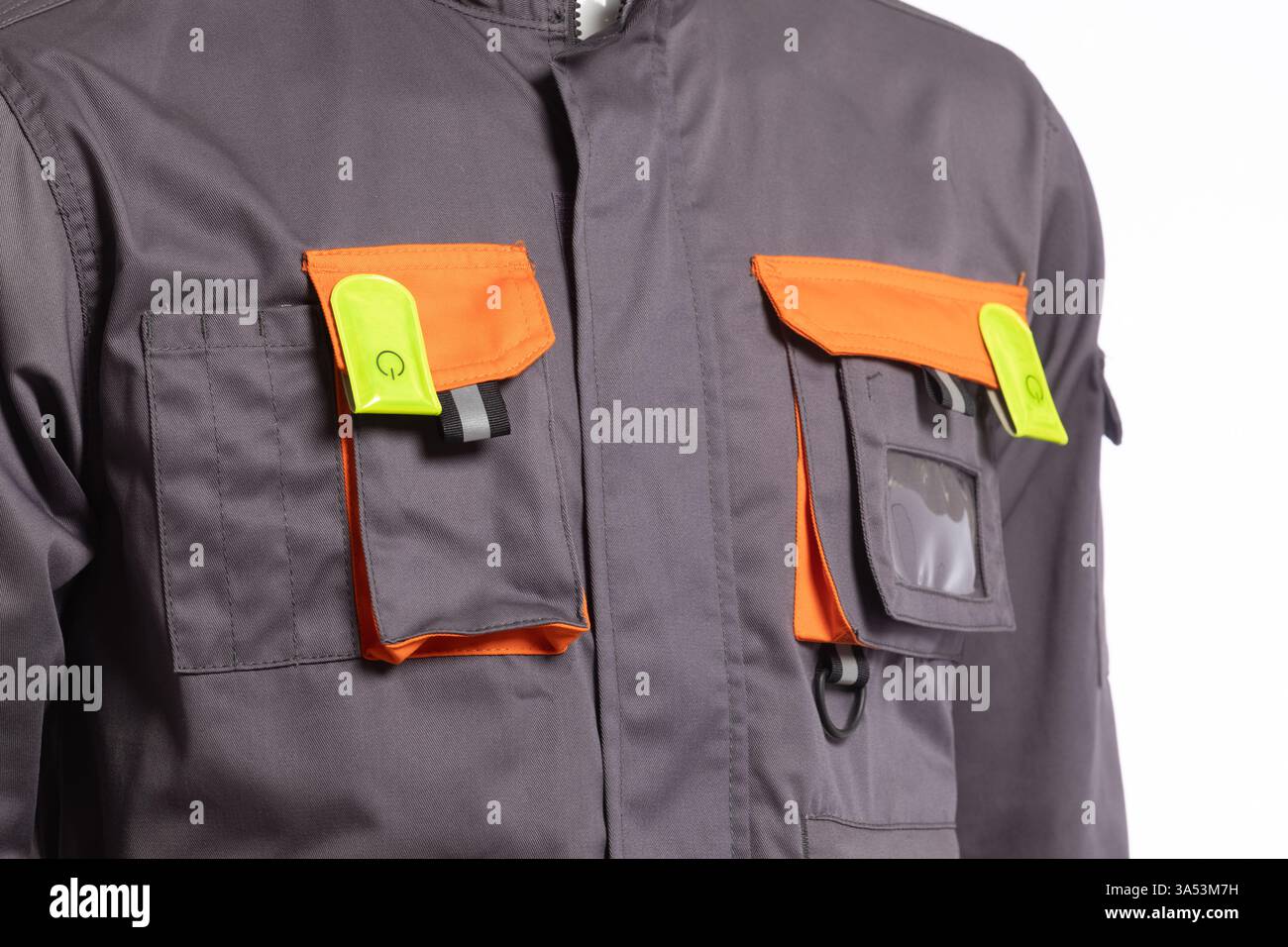 Durable Industrial Work Uniform Featuring Vibrant Orange and Green Pockets Ideal for Safety and Practicality in Various Work Environments Stock Photo