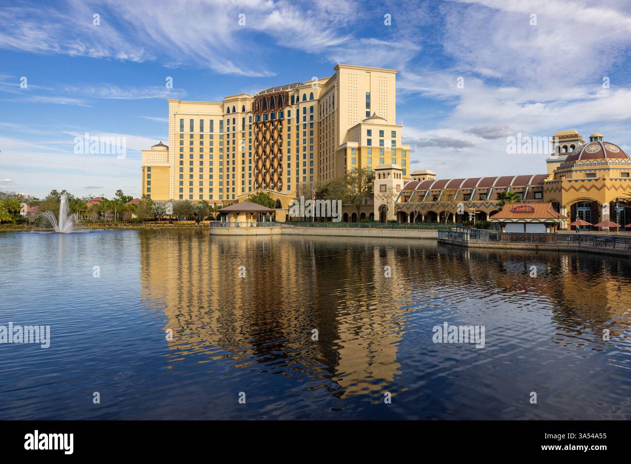 Gran Destino Tower at Disney’s Coronado Springs Resort reflected in Lago Dorado under a clear blue sky, Lake Buena Vista, Florida. Stock Photo