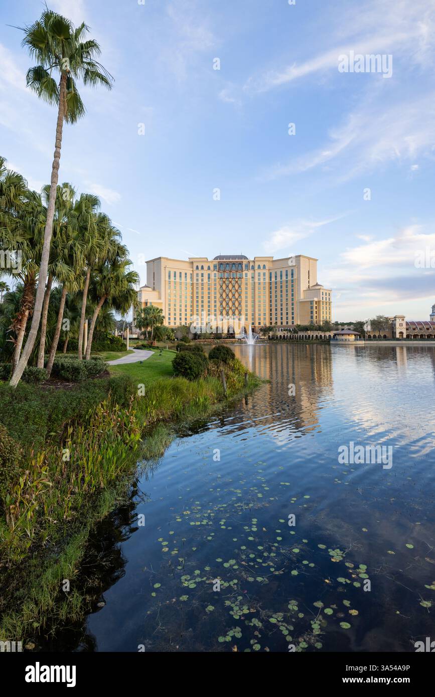 Gran Destino Tower at Disney’s Coronado Springs Resort framed by palm trees beside Lago Dorado, Lake Buena Vista, Florida. Stock Photo