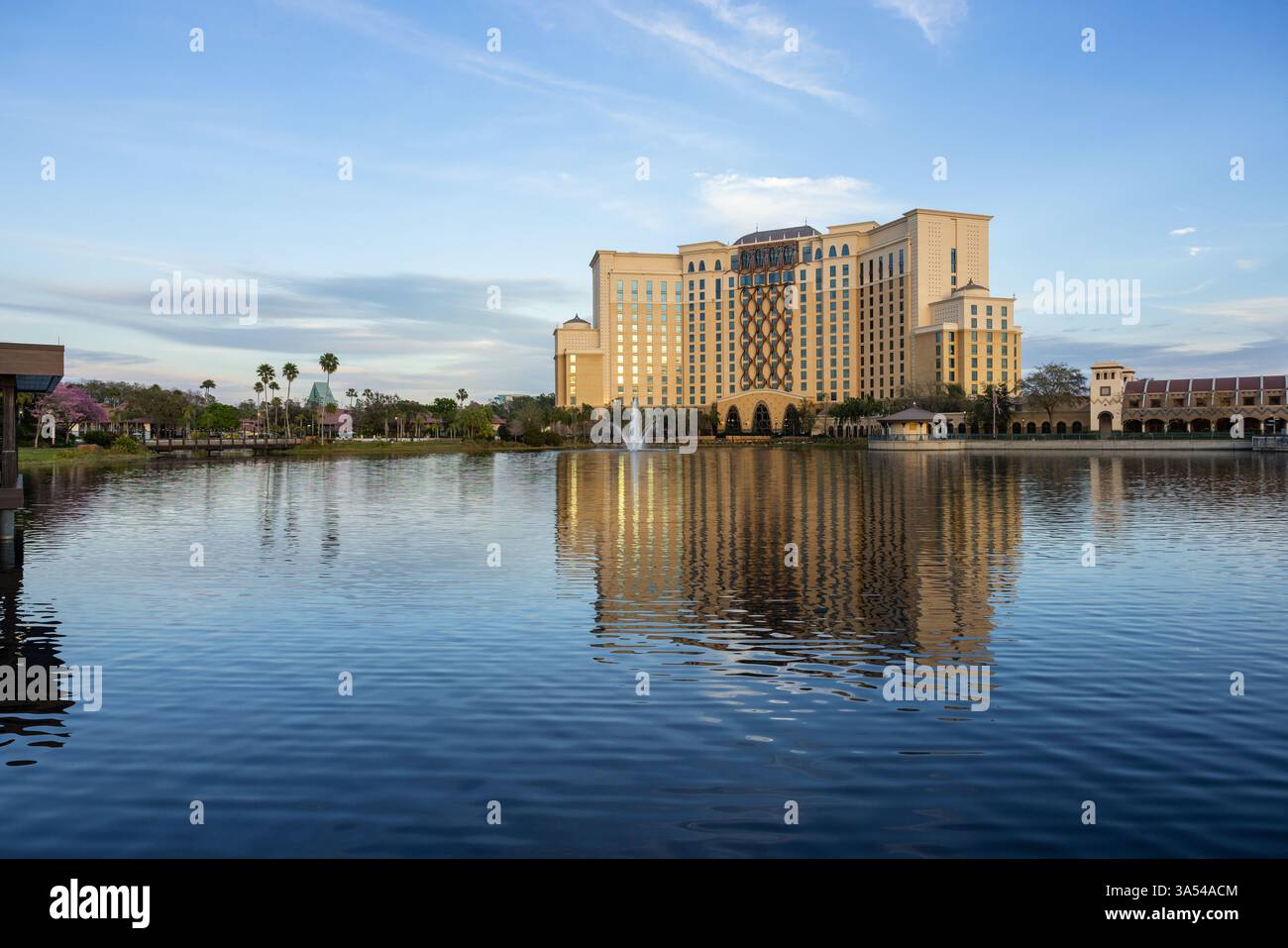 Gran Destino Tower at Disney’s Coronado Springs Resort reflected in Lago Dorado under a clear blue sky, Lake Buena Vista, Florida. Stock Photo
