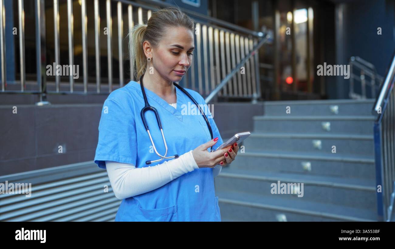 Woman wearing scrubs stands hi-res stock photography and images - Alamy
