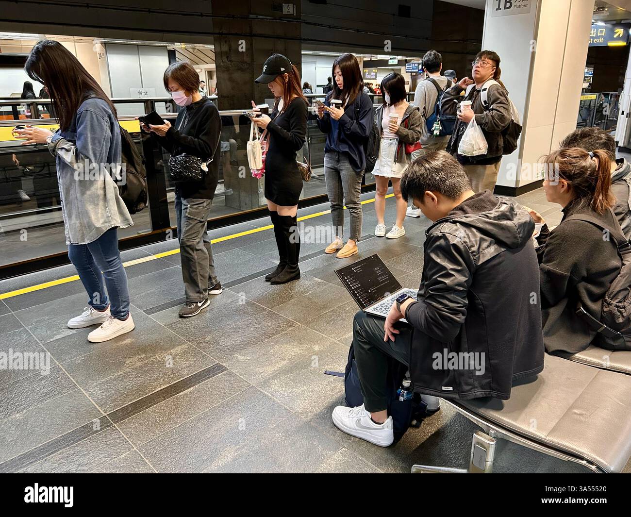 Taipei, Taiwan, Crowd People, Tourists, Traveling, Taipei Main Train Station, Sitting inside, Waiting for High Speed Train, Women Standing on Line - Smartphone Captured Stock Image