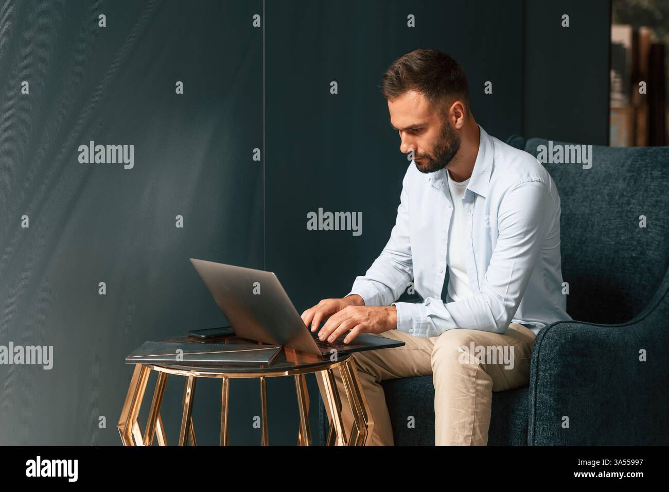 Businessman is sitting and working by using laptop. Stock Photo