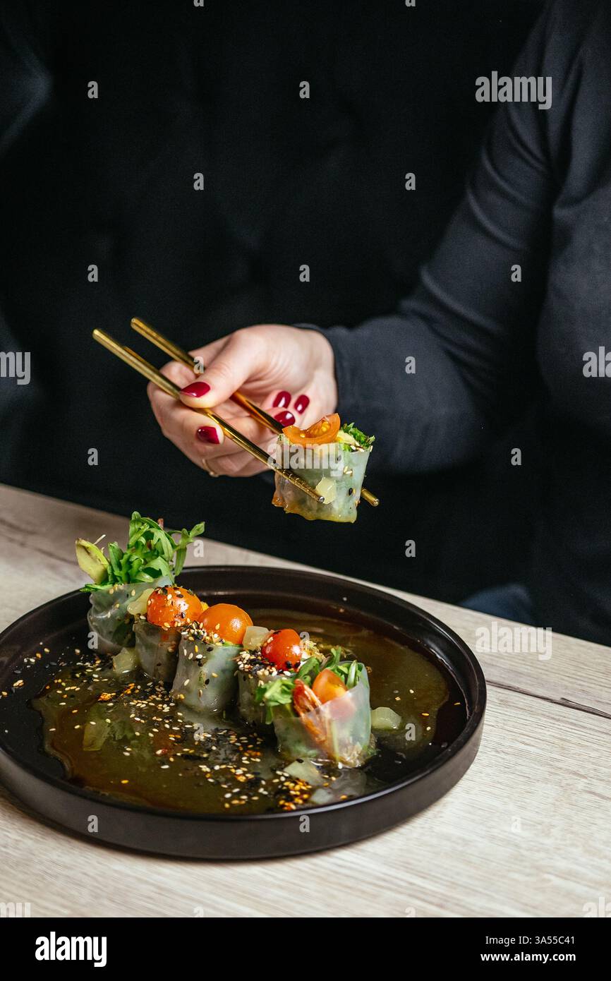 spring rolls in rice paper with chopsticks Stock Photo