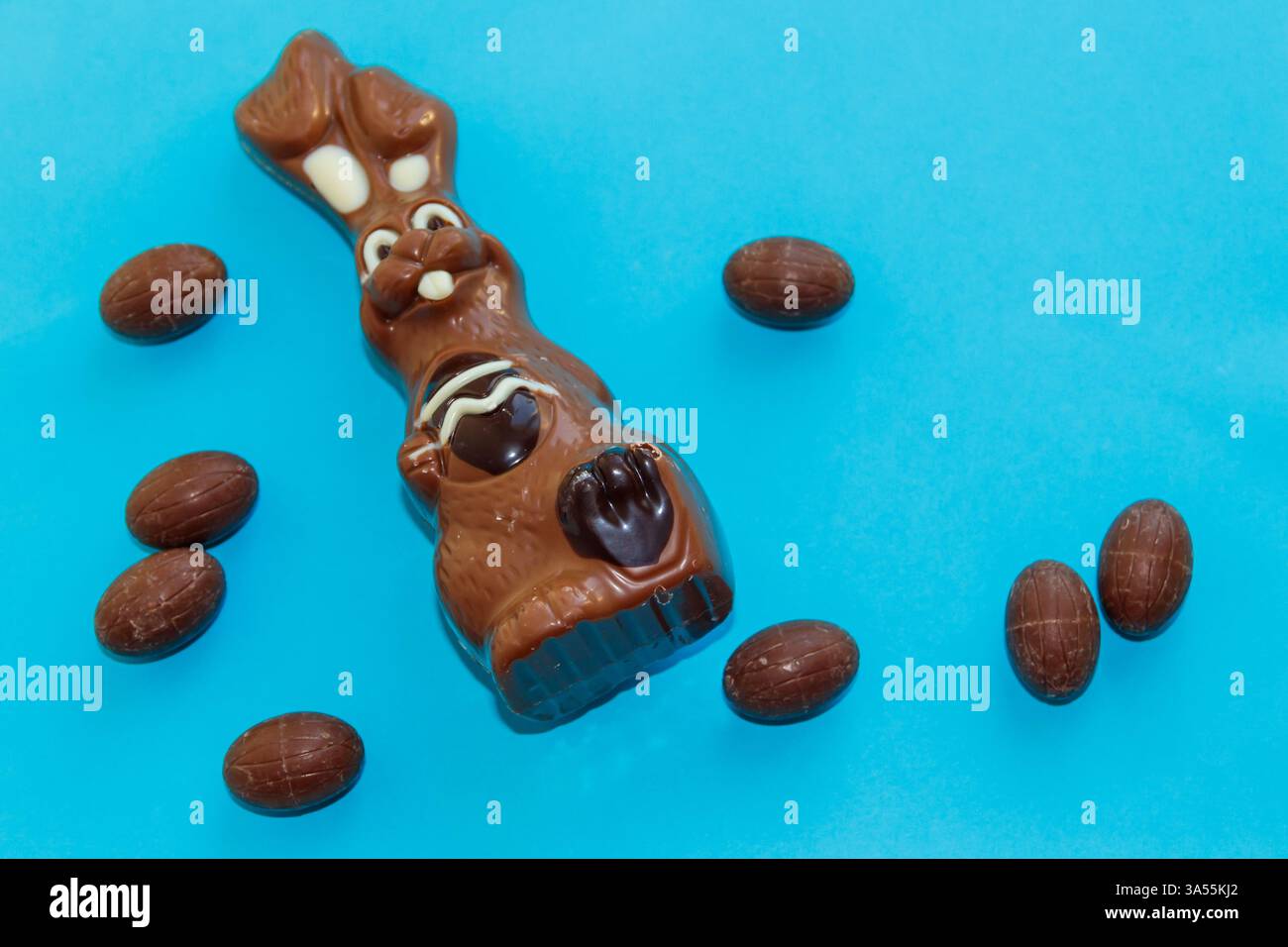 Easter chocolate bunny and chocolate eggs on blue background Stock Photo