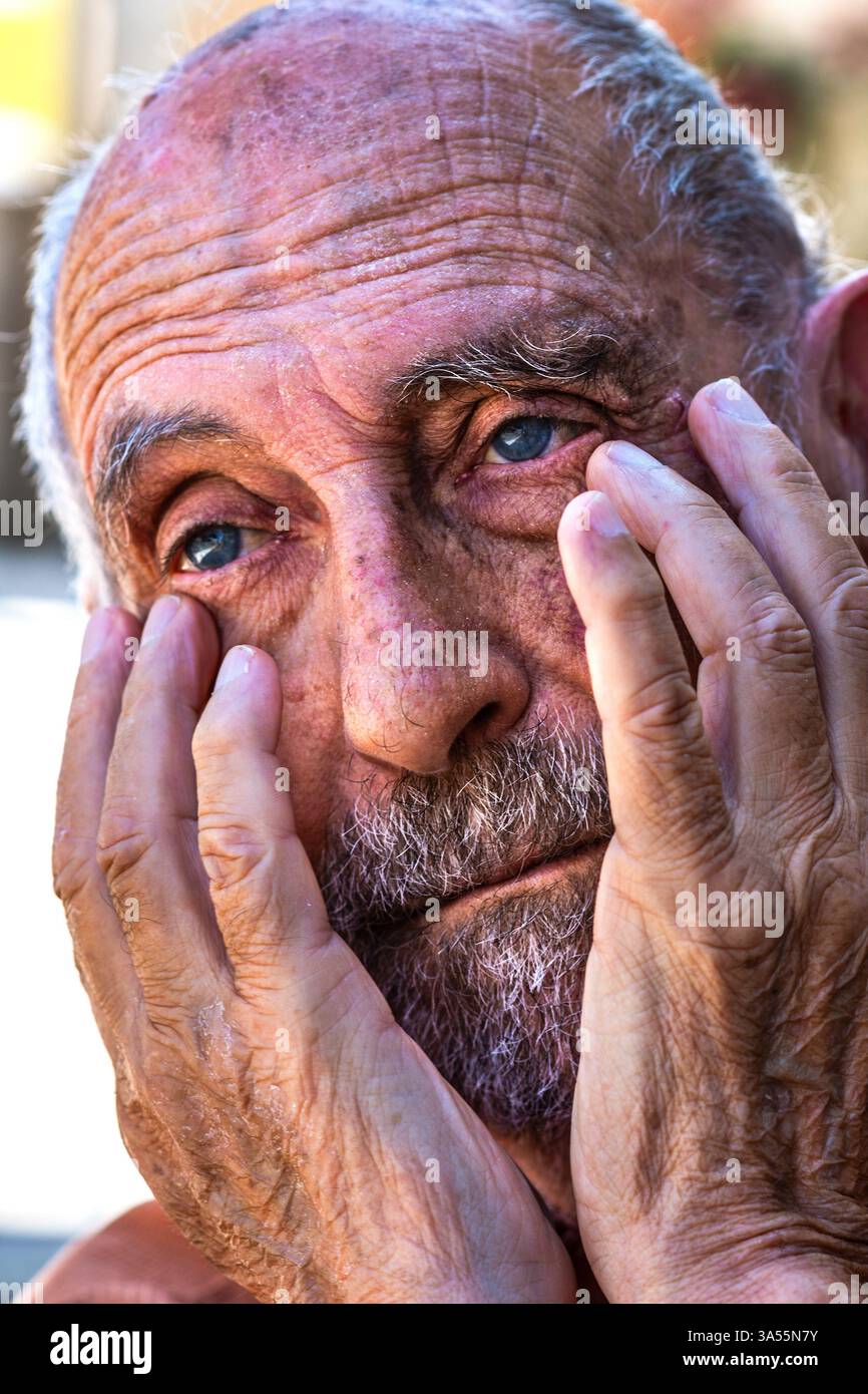 Sad, desolate looking older bearded and balding man with head in hands - Indre-et-Loire (37), France. Stock Photo