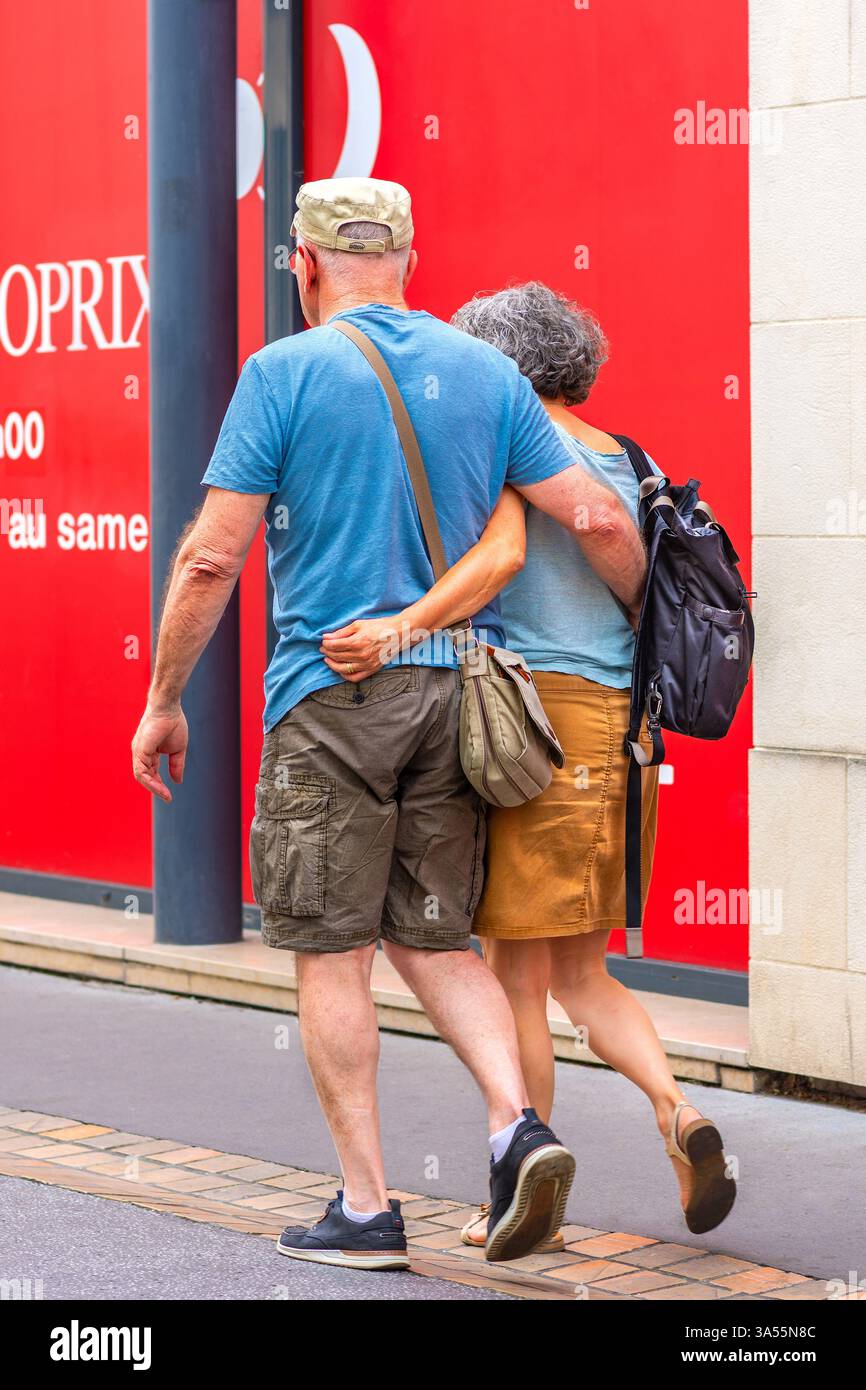 Mature couple walking together with arms around each other - Tours, Indre-et-Loire (37), France. Stock Photo