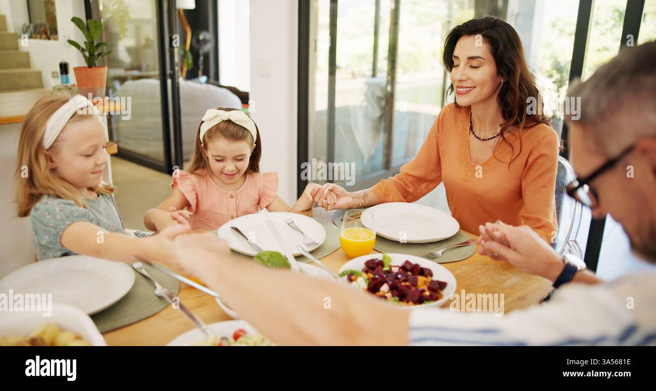 Praying, lunch and family at dining table in home for healthy, wellness ...