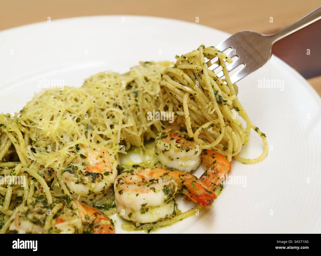 Plate of Delectable Spaghetti with Shrimp and Pesto Stock Photo