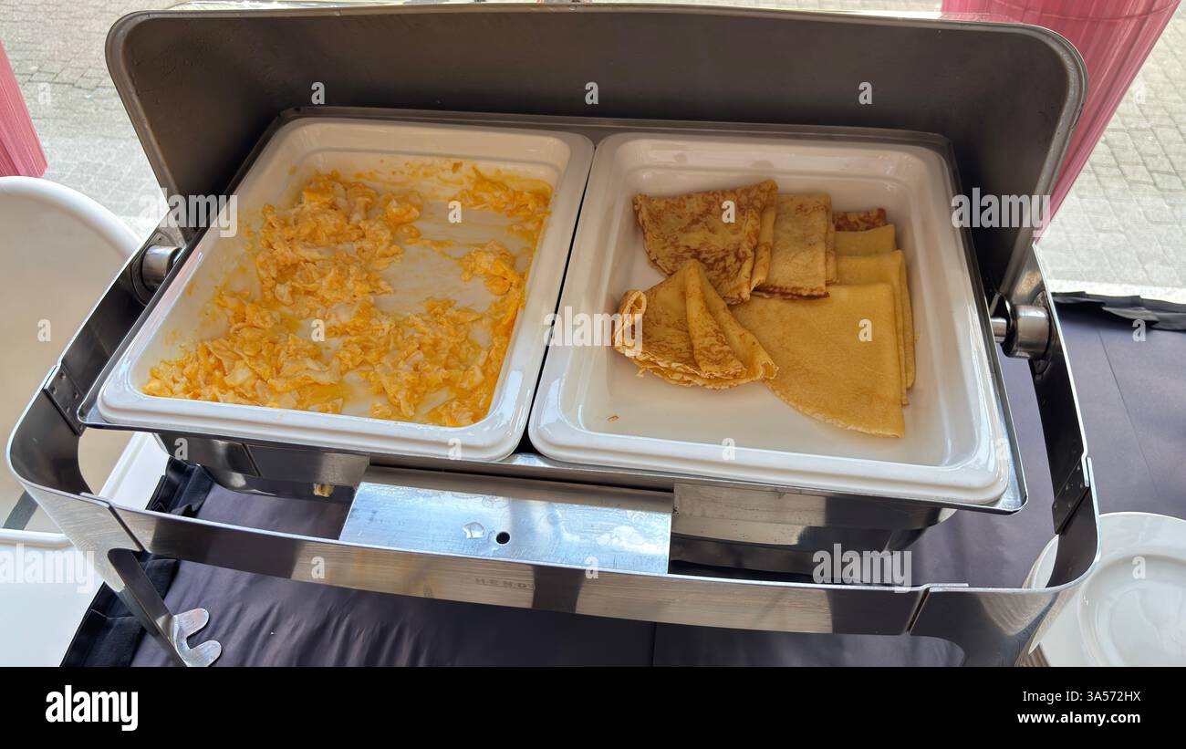 Hot food served in a metal serving plate. Restaurant self service food. Hotel breakfast. Served food. Do it yourself. - Smartphone Captured Stock Image