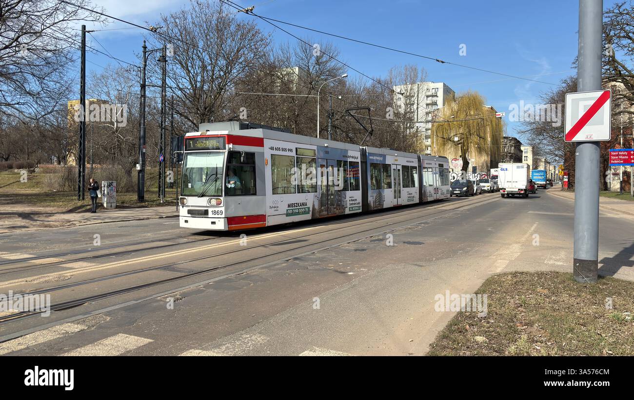 Tram on the streets of Łódź. Polish public transport system. Tram cars. Rail travel. Urban transportation. Metro train in the city centre. Passing fas - Smartphone Captured Stock Image