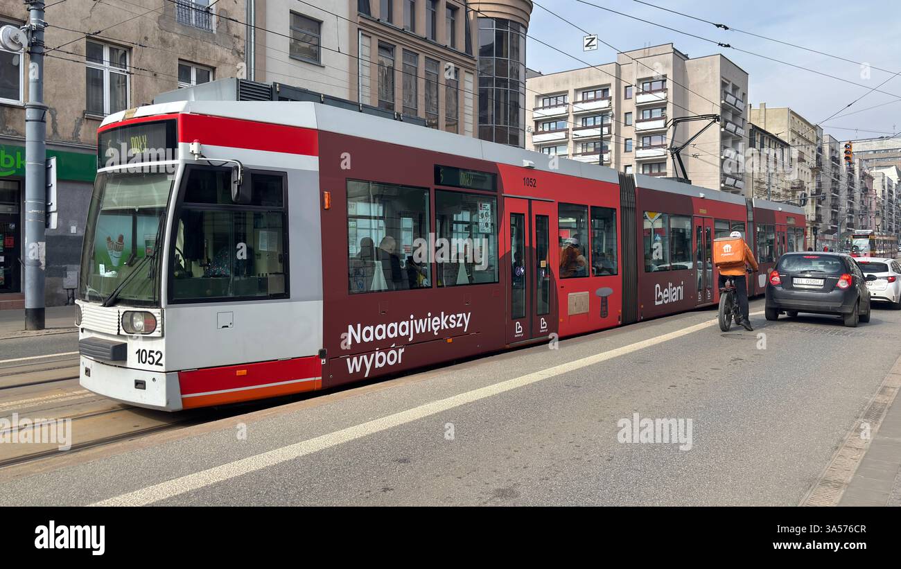 Tram on the streets of Łódź. Polish public transport system. Tram cars. Rail travel. Urban transportation. Metro train in the city centre. Passing fas - Smartphone Captured Stock Image