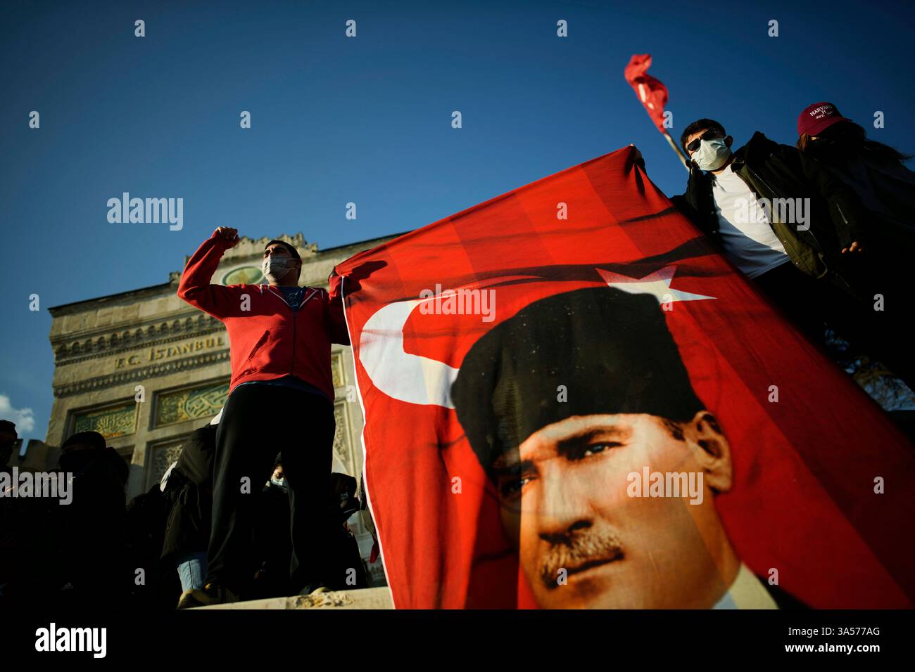University students hold a Turkish flag with the image of Turkey's ...