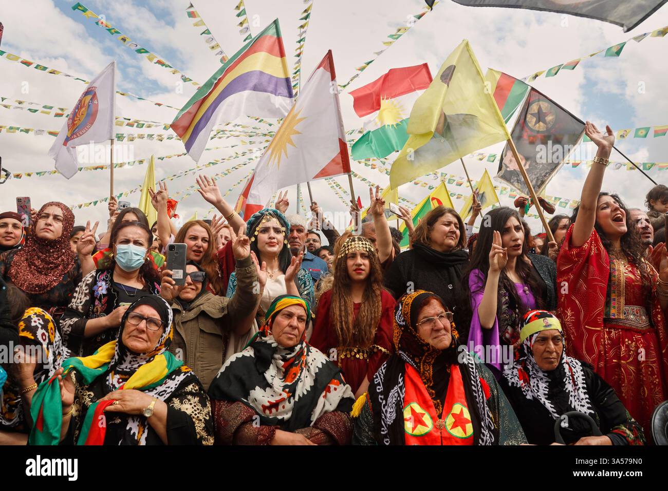 Syrian Kurdish women, most of them wearing traditional clothing, gather ...